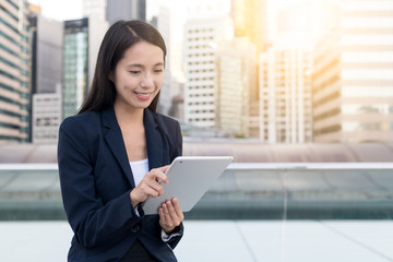 Businesswoman working on mobile phone in the city
