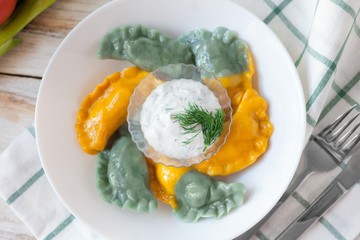 Vareniki called also dumplings, varenyky. Traditional Ukrainian cuisine (food). 
On old wooden white background.
