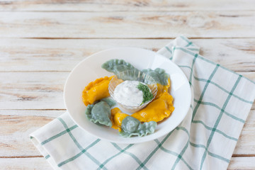 Vareniki called also dumplings, varenyky. Traditional Ukrainian cuisine (food). 
On old wooden white background.
