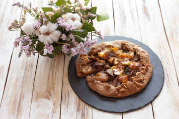 Galette with pears and cheese Brie. Called also Breton galette, galette des Rois, Galeta. French cuisine (food). On old wooden white background.