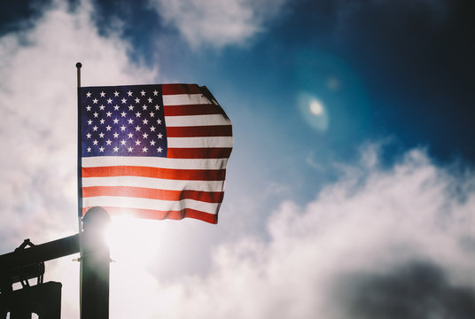 American Flag With Dark Blue Sky And Sun