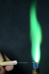 Colored fire caused by an element. Copper (Cu) causes a deep green golor.