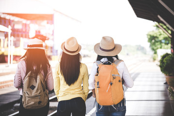 Group of asia women traveler and tourist  traveling backpack holding map and waiting in a train station platform.  Travel Concept.
