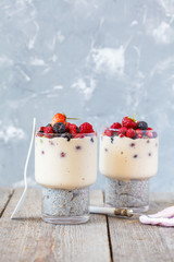 Healthy chia pudding with smoothies and berries in a glass.