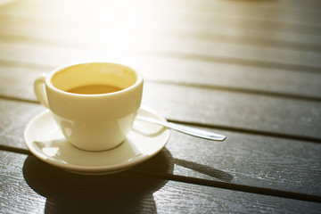 Cup of coffee on wooden table.