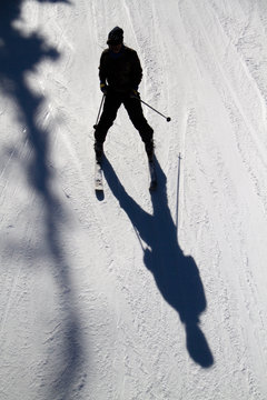 Person skiing on long shadow