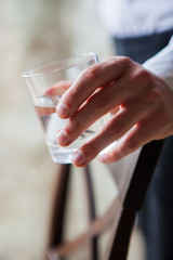 Close up man holding glass of drinking water