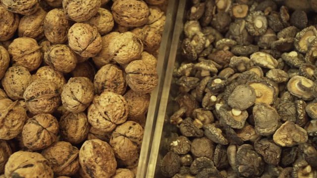 Walnuts and dried mushrooms sold in supermarket stock footage video