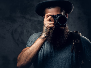 A man holds compact photo camera. - Powered by Adobe