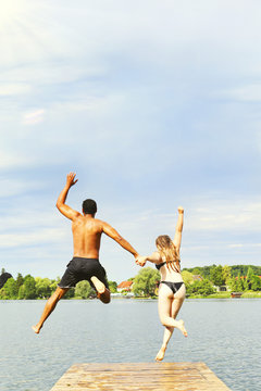 Couple Jumping Into Lake