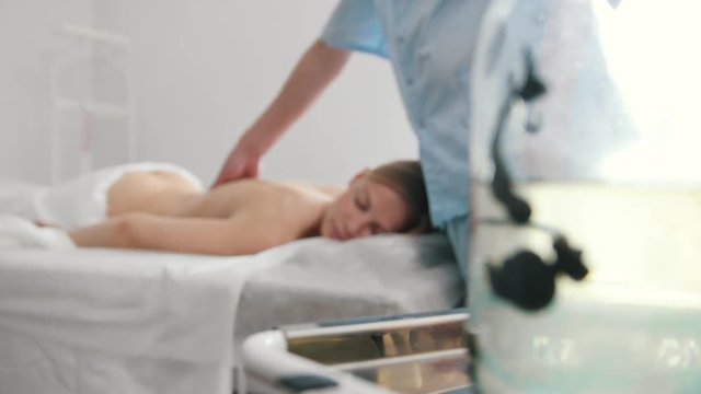 Tibet therapy - massage, hirudotherapy - leeches in clinic, blonde model woman patient