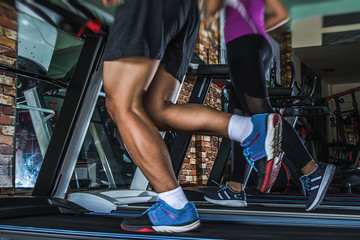 People running in machine treadmill at fitness gym club