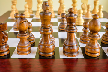 Closeup focused and blurred view of wooden chess set; strategy; game background