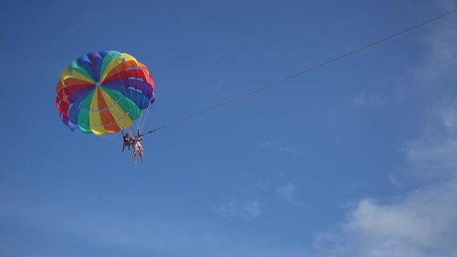 4k video of traveler parasailing with speed boat over the sea