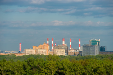 Fototapeta na wymiar View of the district of the city of Moscow with high-rise buildings and pipes of a thermal power plant