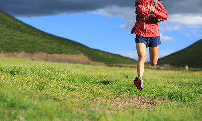 young fitness woman trail runner running outside