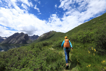Fototapeta na wymiar young backpacking woman hiking in mountains
