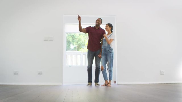 Excited Young Couple Moving Into New Home Together