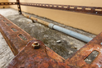 rusty nut and bolt locked with rust on rusty Slotted Angle Steel