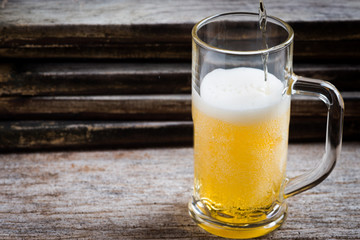 mug of beer on wood background