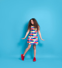 Trendy hipster girl in colorful dress