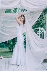 Relaxed girl  sitting on sailboat, enjoying mild sunlight, fashion model in luxury sea cruise, summer vacation and travel.