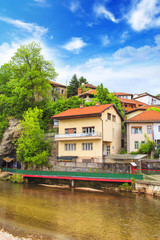 Fototapeta na wymiar View of the architecture and embankment of the Milyacki River in the historical center of Sarajevo, Bosnia and Herzegovina