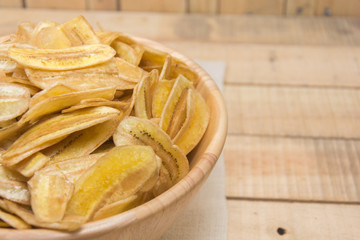  sweet banana crisps on wooden bowl