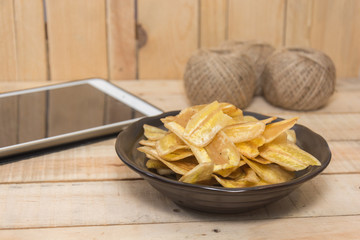  sweet banana crisps on wooden bowl