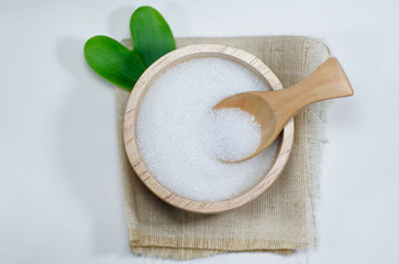 white sugar on wooden spoon