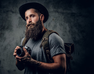 A man holds compact photo camera.