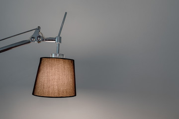 Footlamp against grey wall