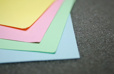 Multi-colored paper, such as pink, blue, green, yellow for the blur background.