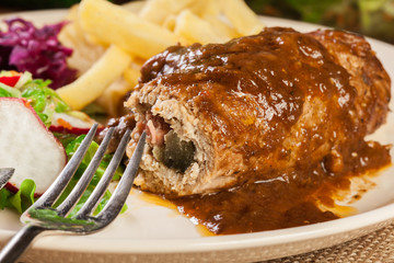 Pork roulade with french fries with salad