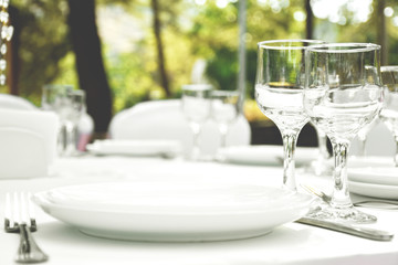 Tableware - cutlery and white plates.