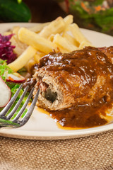 Pork roulade with french fries with salad