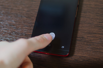 Fingerprint scanner on the phone screen. Touch screen smartphone with a zone to touch the human finger, to unlock the device.
