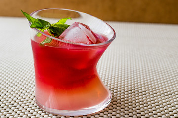 Malibu Sunset Cocktail with mint leaves..