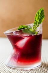 Malibu Sunset Cocktail with mint leaves..