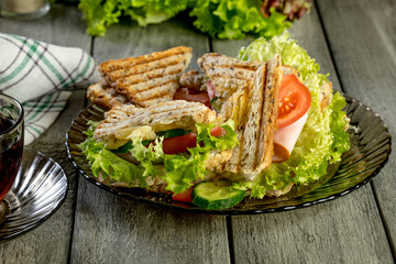 Panini sandwich with ham, tomato and lettuce.