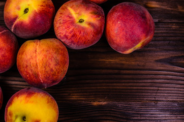 Fototapeta na wymiar Fresh ripe peaches on wooden table. Top view