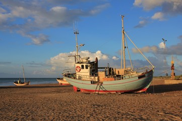 Summer day at Slettestrand, Jammerbugten. Fishing boat on the shore.