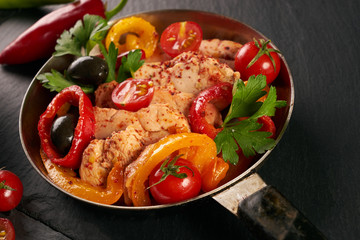 Fried chicken with vegetables on the pan and Italian pasta with a parmesan cheese basil olives paprica and tomatoes on a plate. Healthy food copncept. Top view copy space.