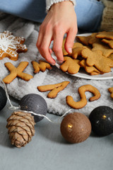 XMAS cookies, female hand and garland