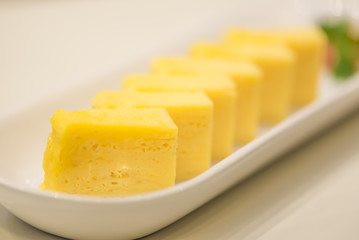 Sweet omelet egg Japanese style in white plate.