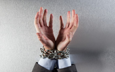 desperate man hands tied with chain begging for employee victim