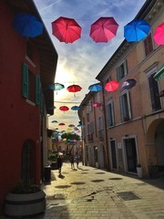 colorful umbrellas in the city center in Italy