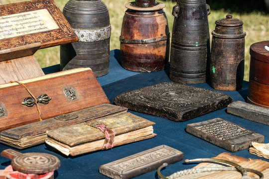 old Tibetan praying books and milk wooden containers in display