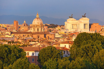 Fototapeta premium Panoramic aerial wonderful view of Rome with Altar of the Fatherland and churches at sunset time in Rome, Italy