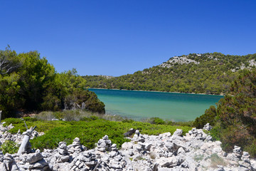 Piles of stones in Telascica Nature Park and lake Mir in the backgrounds, Dalmatia, Croatia